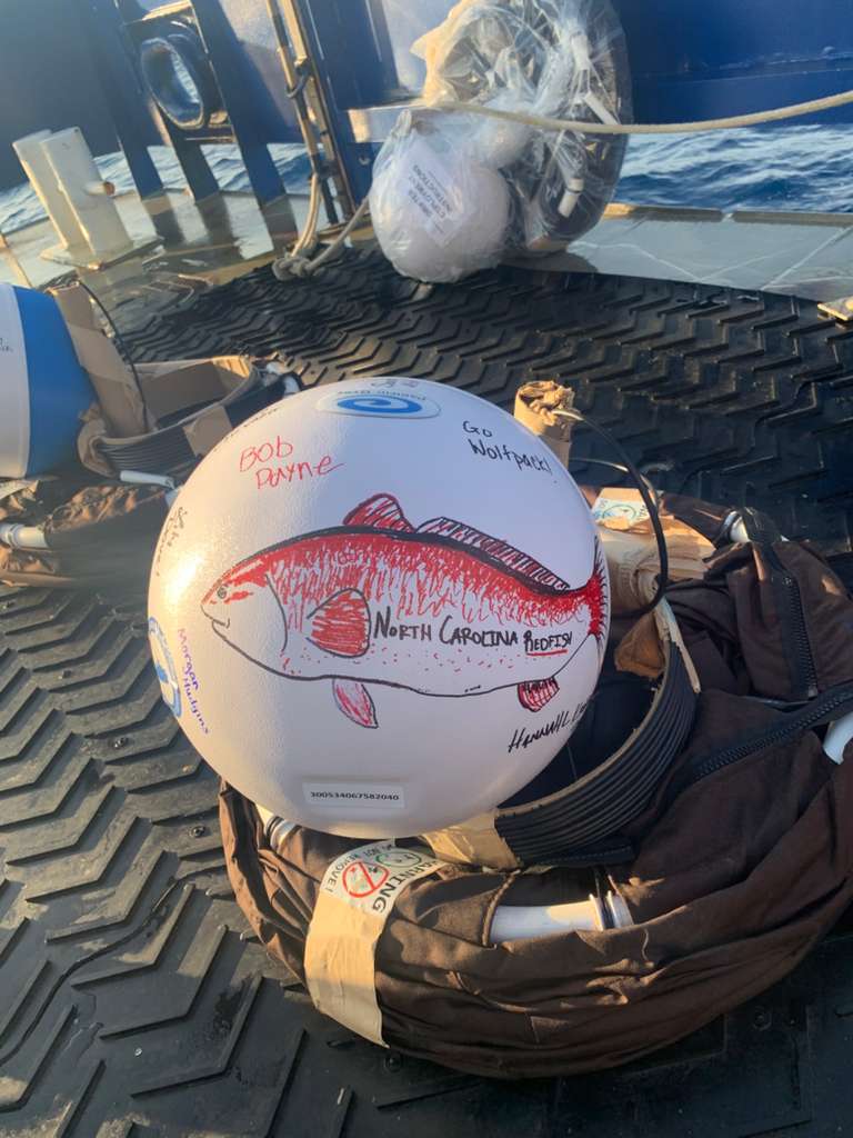 Instrumented surface drifter decorated with a North Carolina redfish, ready for deployment during the June 2026 Gulf Stream cruise